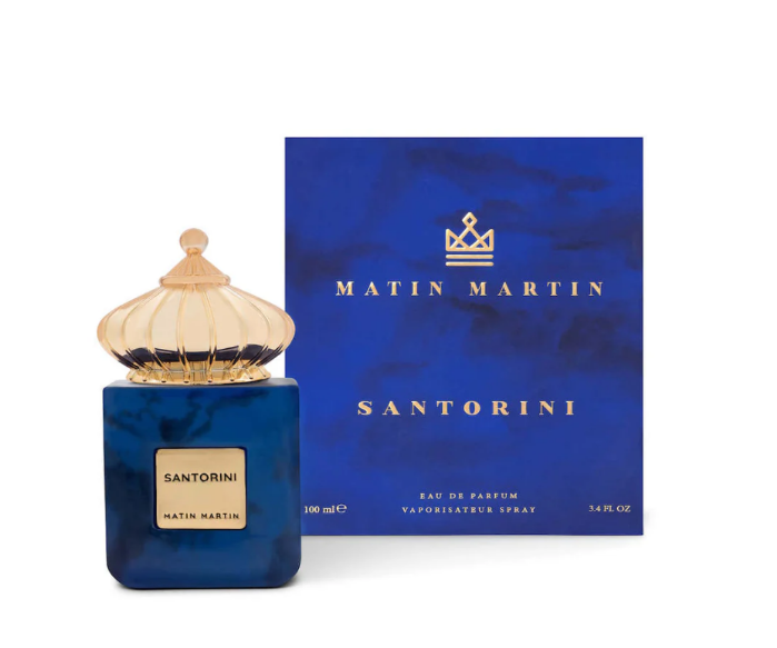 A bottle of Santorini EDP 100ml by Matin Martin with a blue marbled design and a gold-colored cap.