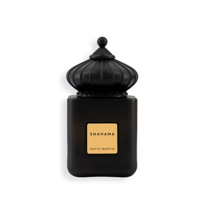 A black bottle of Shahama EDP 100ml by Matin Martin with a crown-like cap, set against a blurred background with water droplets.