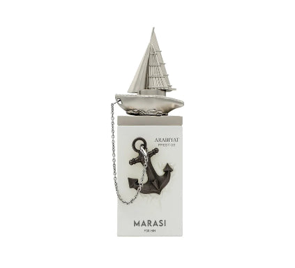 A silver-toned metal keychain featuring a miniature sailboat on top of a rectangular box. A dark anchor charm hangs from a short chain, and the box is branded with 'ARABHYAT PRIMITIVO' and 'MARASI'.