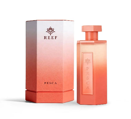 Coral-colored perfume bottle and packaging with 'REEF' branding on a white background