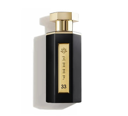 Perfume bottle with gold cap and 'REEF 33' branding on a white background