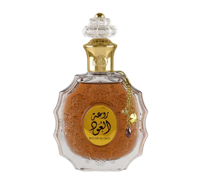 Decorative perfume bottle with gold and clear design on a white background