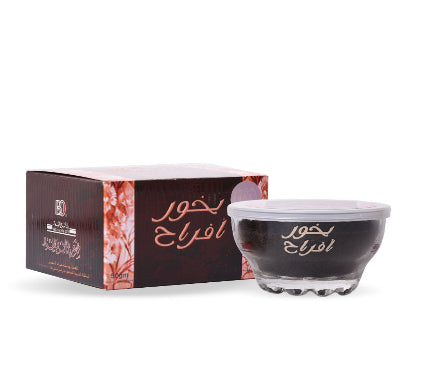 Black container with white lid and Arabic text on a white background