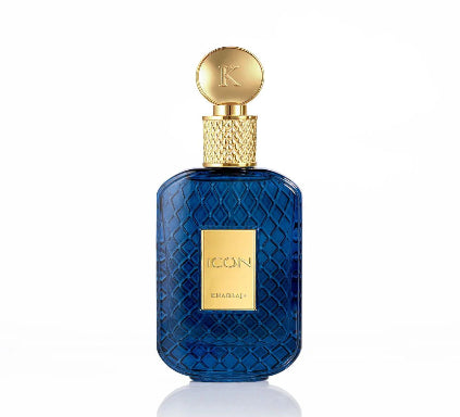 Chad Laiselier Icon fragrance bottle in textured deep blue glass with a gold cap and gold front label, shown on a white background with a soft reflection.