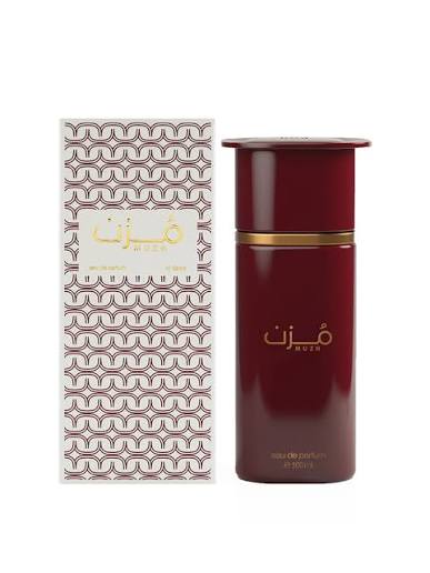 Muz - Muzah perfume bottle and packaging box. The bottle is a deep burgundy red with a gold band and gold lettering, standing next to its patterned white and brown box.