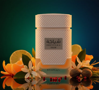 White perfume bottle with textured design and 'Shiyaaka Snow' label on a white background